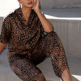 A woman wears the Pele Shirt in Bronze Animal, a satin shirt with a relaxed dropped shoulder and fashionable leopard print animal design. Made in Australia for women size 8-24.