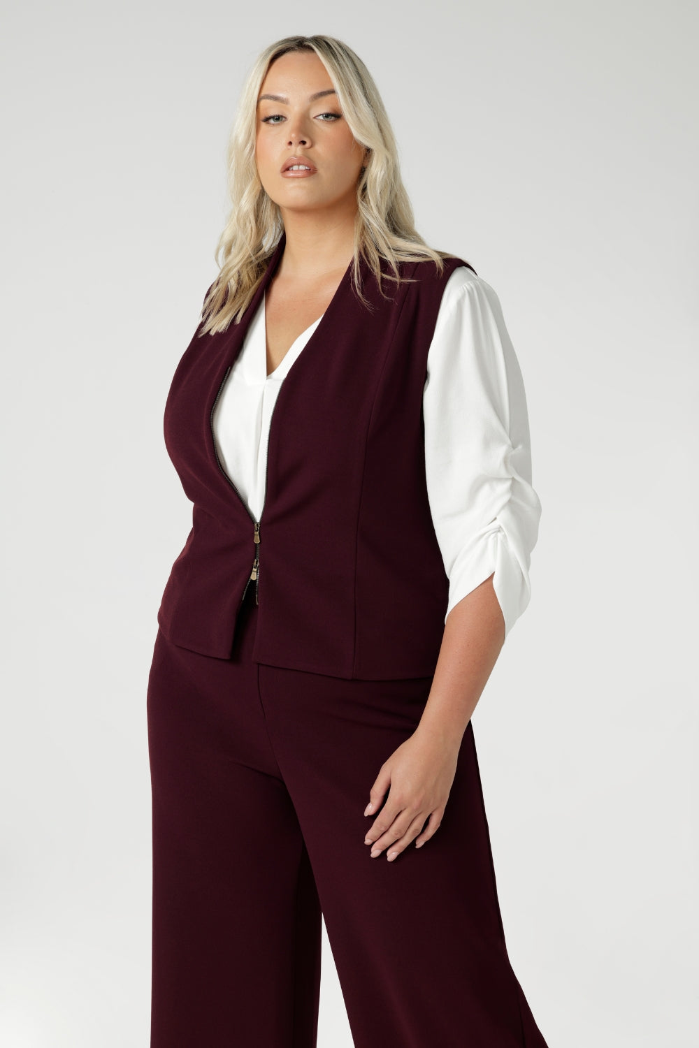 Women's wine coloured suiting vest features a flattering V-neck and is sleeveless for a modern, sleek look. It’s double ended, two-way zip, offers versatility, ease of movement and endless styling options. Available in sizes 8-24.