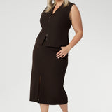 The fitted vest features a flattering V-neckline, sleeveless design, and a two-way opening zip for added flexibility. It also includes back side panels for a tailored fit and is available in sizes 8-24. 