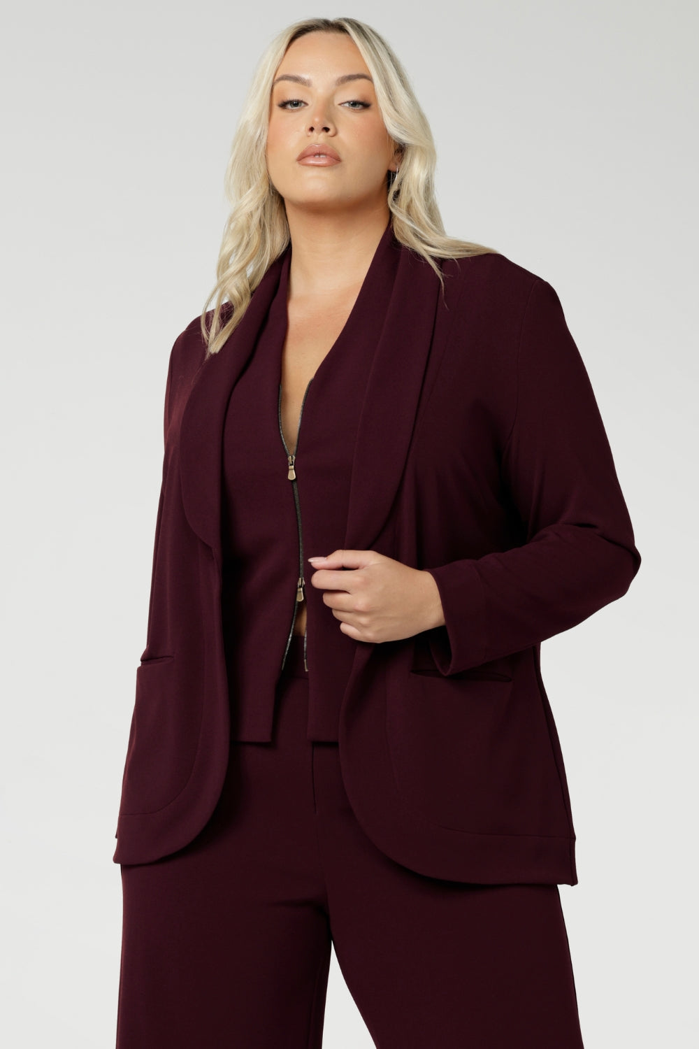 Women's wine coloured suiting vest features a flattering V-neck and is sleeveless for a modern, sleek look. It’s double ended, two-way zip, offers versatility, ease of movement and endless styling options. Available in sizes 8-24.