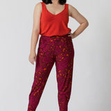 Petite model wears paisley printed travel pants. This pull-on style ensures a relaxed fit, making them effortless to wear for busy days and travel adventures. 
