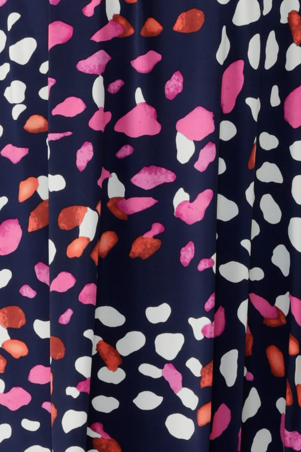 Fabric swatch of L&F Pink Mariposa print.  A fuchsia, red, and white abstract print on a navy, slinky jersey base. This fabric has soft stretch. Used by Australian clothing label Leina & Fleur to make women’s dresses and tops.