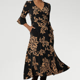 A beautifully crafted midi wrap dress that combines effortless elegance with everyday comfort. Falling just below the knee, this flattering A-line silhouette is designed in a soft, stretchy jersey fabric that moves with you. 
