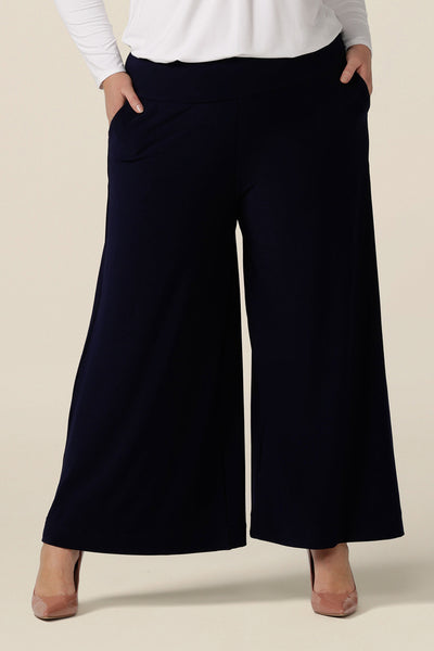 Navy blue wide leg pants with pockets, shown in size 18 These pull-on, easy care pants are comfortable for your everyday workwear capsule wardrobe. Shop these Australian-made navy trousers online in sizes 8 to 24, petite to plus sizes.
