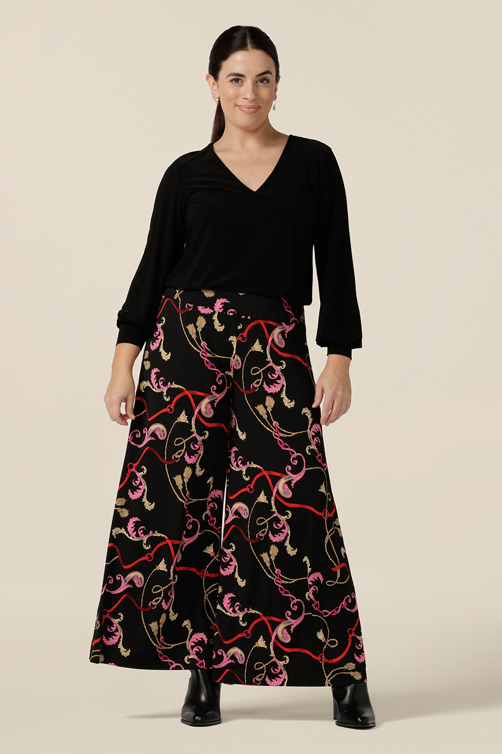 A size 10, petite height woman wears wide leg pull-on pants in rococo Tassel print stretch jersey. Comfortable pants for work and casual wear, these cropped trousers are made in Australia by women's clothing brand, Leina & Fleur.