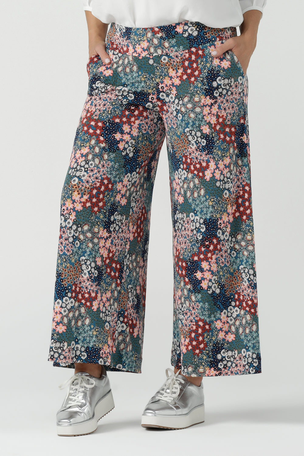 Close up of a size 10 woman wears the Presley Pant in Whimsy, a wide leg pant with a Whimsy print. A made in Australia wide leg pant with a ditsy floral print print. Size inclusive fashion for women size 8-24