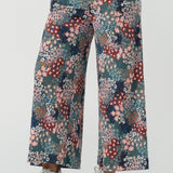 Close up of a size 10 woman wears the Presley Pant in Whimsy, a wide leg pant with a Whimsy print. A made in Australia wide leg pant with a ditsy floral print print. Size inclusive fashion for women size 8-24