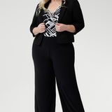 The Puzzle Jumpsuit in Moderno is a statement-making one-piece crafted from our signature dry-touch jersey with soft stretch, designed to offer effortless style and all-day comfort. Showcasing a striking black and white geometric print across the wrap-style bodice, this jumpsuit features a flattering self-tie waist and a double-layered back for a refined and supportive fit.