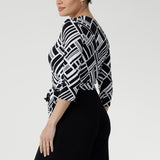 The contrast black jersey pants fall to a full length with a sleek straight leg and include functional side pockets, blending elegance with everyday ease. 