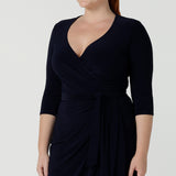 Size 12 woman wears the Robin dress in Navy. Midi length with 3/4 sleeves. V-neckline with a functioning wrap. A great work to weekend piece. Made in Australia for women size 8 - 24.