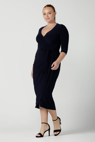 Size 12 woman wears the Robin dress in Navy. Midi length with 3/4 sleeves. V-neckline with a functioning wrap. A great work to weekend piece. Made in Australia for women size 8 - 24.