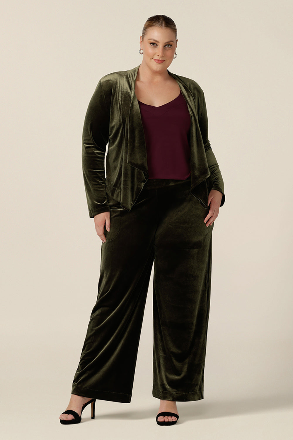 The best cocktail pant suit for women with curve, the Deni Pant and Romy Jacket wear together with a plum cami top for a lougewear tuxedo look. Straight, wide leg pants in green velour, these evening trousers are pull on pants and comfortable in stretch fabric. Shop plus size occasion and cocktail attire online at Australian fashion brand, Leina & Fleur.