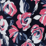 Close up fabric image. Material used to create floral fabric is dry touch jersey. Fabric is navy in colour with pink and white flowers. Crafted for Australian and New Zealand women in Australia. Leina & Fleur is a women's clothing retailer that have sizes from 8-24 in petite & plus sizes.