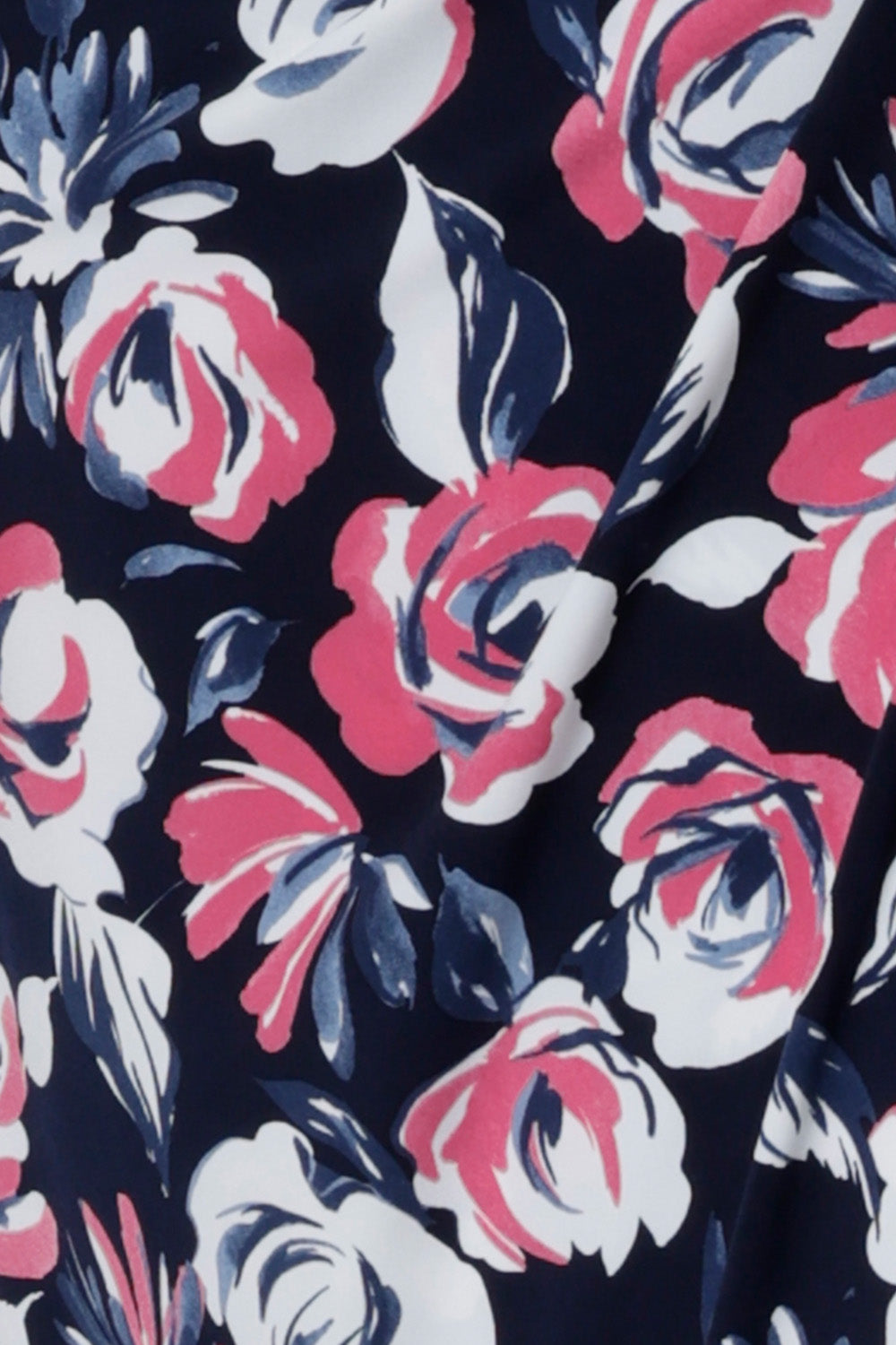 Close up fabric image. Material used to create floral fabric is dry touch jersey. Fabric is navy in colour with pink and white flowers. Crafted for Australian and New Zealand women in Australia. Leina & Fleur is a women's clothing retailer that have sizes from 8-24 in petite & plus sizes.