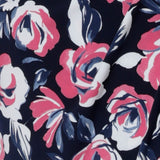 Close up fabric image. Material used to create floral fabric is dry touch jersey. Fabric is navy in colour with pink and white flowers. Crafted for Australian and New Zealand women in Australia. Leina & Fleur is a women's clothing retailer that have sizes from 8-24 in petite & plus sizes.