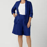Women wears the Houston Blazer in Cobalt linen size 12. Styled back with a matching Cobalt Linen Blazer with a button front and patch pockets. Made in Australia for women size 8 to 24.