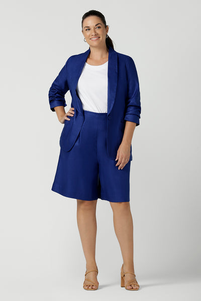 Women wears the Houston Blazer in Cobalt linen size 12. Styled back with a matching Cobalt Linen Blazer with a button front and patch pockets. Made in Australia for women size 8 to 24.