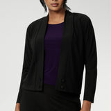 Over 30's woman wears a black V-neck jacardi with long sleeves. Designed to help women in Australia and New Zealand transition for cool weather. This jacket/cardigan is a transeasonal cover-up made from stretchy jersey fabric. Shop this jacket-cardigan hybrid in sizes 8-24.