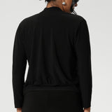 Back view image of size 10 woman, wearing black V-neck jacardi that features long sleeves, v neck & buttons. Designed to help women in Australia and New Zealand transition for the cooler months.. This jacket/cardigan is a transeasonal cover-up made from stretchy jersey fabric. Shop this jacket-cardigan hybrid in sizes 8-24.