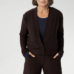 Mature aged woman wears the Sandro Jacardi in Cocoa which is a jacket-like cardigan that effortlessly adds layered dresses, making it an essential piece in our Fluid Suiting collection. Crafted from a heavyweight dry-touch jersey fabric with a soft stretch, this cardigan offers both comfort and structure.