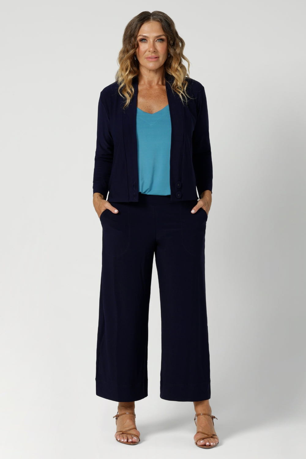 Size 12 woman wears a perfect trans-seasonal cover up for the cooler months or for comfort in her workplace. Comfortable jacket provides elevated workwear styling when paired back with matching pants, for a soft suiting look. Available in sizes 8-24.