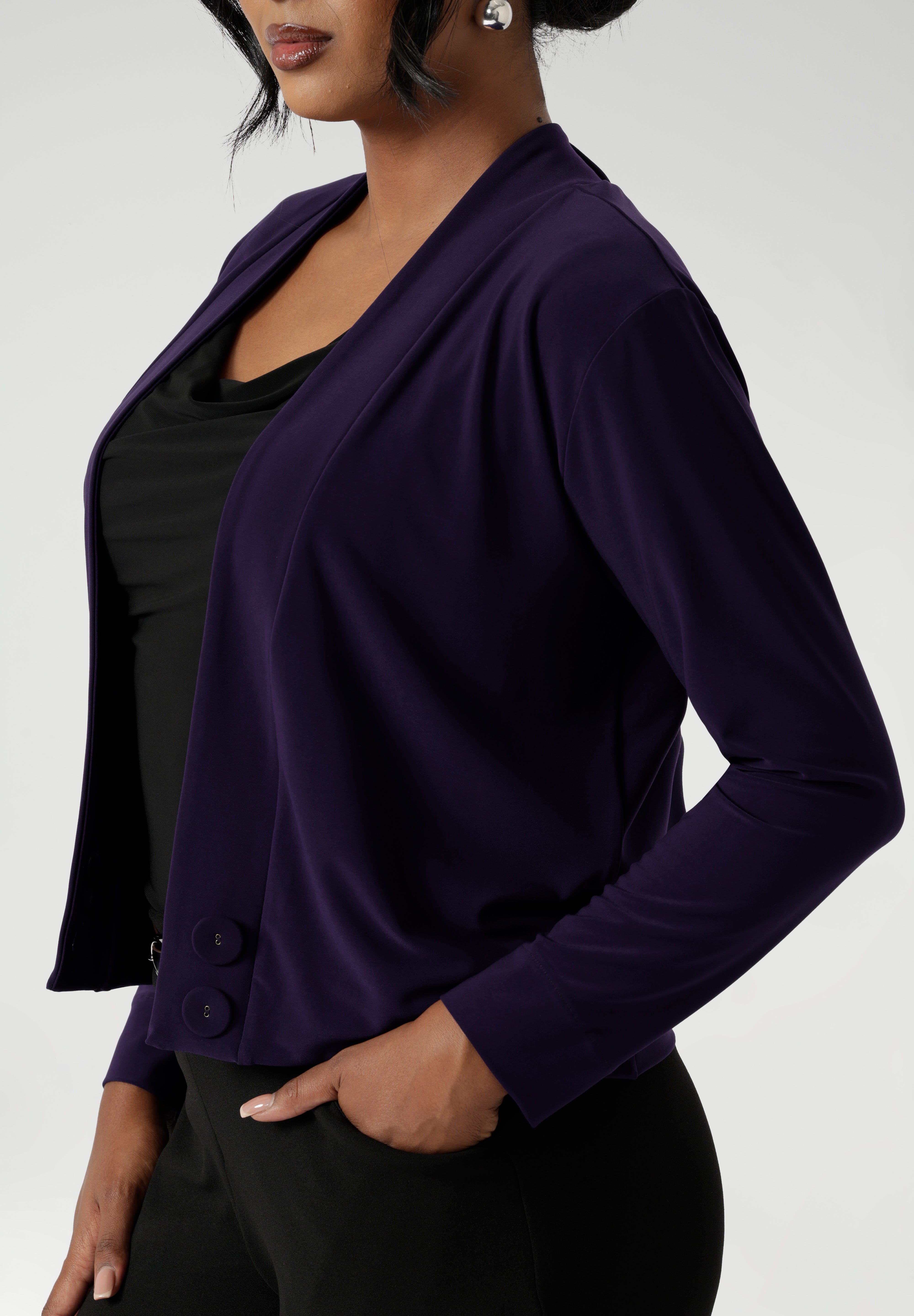 This stylish cardigan features a deep V-neckline that creates a flattering and elegant silhouette. It includes two covered button fastenings for a refined, minimalist look, while the long sleeves provide coverage and warmth when needed.