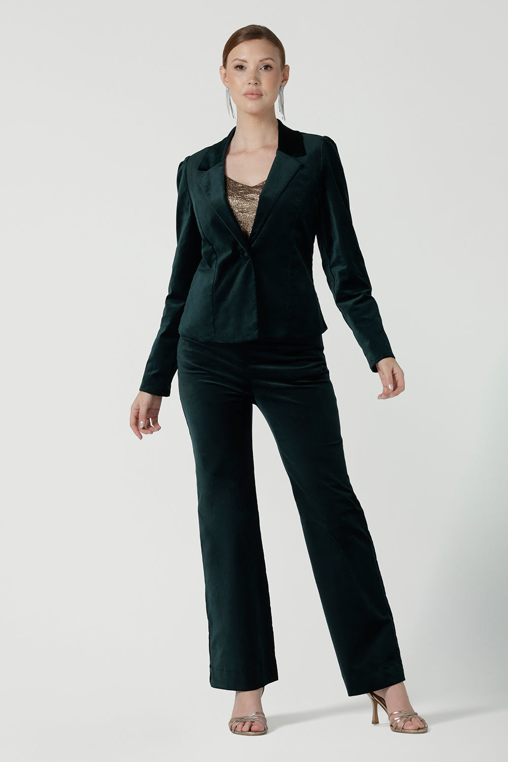 A size 10 woman wears the Sasha Jacket in Green Velveteen. A cocktail pant suit set made in Australia for women. Cocktail pant suit sets for women size 8 - 24. Styled back with the Matisse shirt with a tie neckline. Style back with the Jonas pant in green.