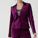 A size 10 woman wears the Sasha jacket in Magenta velveteen. A cocktail pant suit that is made in Australia for size 8 - 24. A matching suit set in velveteen. Event wear for petite to plus size women. 