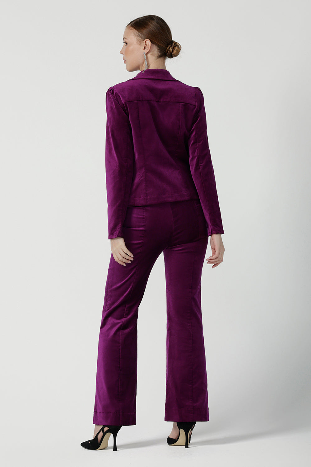 Back view of a size 10 woman wears the Sasha jacket in Magenta velveteen. A cocktail pant suit that is made in Australia for size 8 - 24. A matching suit set in velveteen. Event wear for petite to plus size women. Styled back with the Jonas pant. 