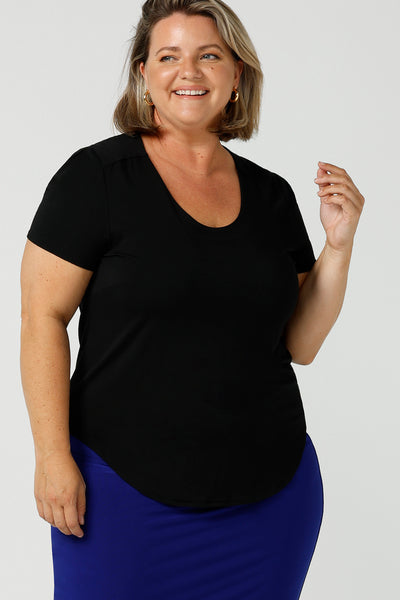 A good plus size top, this round neck, short sleeve top in black bamboo jersey is comfortable for work and casual wear. Worn by a curvy, size 18 woman, this top is made in Australia by ladies clothing brand, Leina & Fleur. Shop black tops for women online in sizes 8 to 24 in L&F's online fashion boutique.