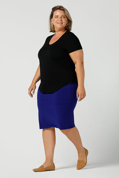A good plus size top, this round neck, short sleeve top in black bamboo jersey is comfortable for work and casual wear. Worn with a cobalt blue tube skirt, both top and skirt are made in Australia by ladies clothing brand, Leina & Fleur, shop black tops for women online in sizes 8 to 24 in L&F's online fashion boutique.