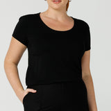 A good black top for your capsule wardrobe, this round neck, short sleeve top in black bamboo jersey is comfortable for work and casual wear. Made in Australia by ladies clothing brand, Leina & Fleur this black tee top is worn by a size 12 curvy woman. Shop black tops for women online in sizes 8 to 24 in L&F's online fashion boutique.