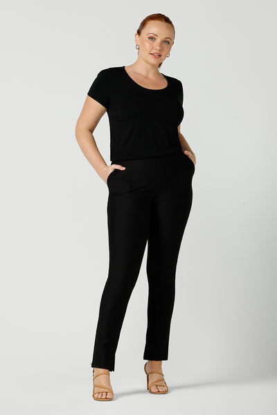 A good black top for your capsule wardrobe, this round neck, short sleeve top in black bamboo jersey is comfortable for work and casual wear. Worn with slim leg black work pants, both are made in Australia by women's clothing brand, Leina & Fleur. Shop black tops for women in Australia online in sizes 8 to 24 in L&F's online fashion boutique