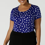 Size 16 curvy woman wears a scoop neckline top on a polka dot print with a cobalt base. Made in Australia for women size 8 to 24.