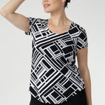 The Sawyer Top in Moderno is crafted from our signature dry-touch stretch jersey, offering the perfect balance of structure and softness for everyday wear. Designed with a flattering fitted silhouette, this versatile top features a classic round neckline, short sleeves, and a curved shirttail hemline that adds a modern touch to any outfit.