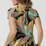 Back view of a size 10 woman wears the Sawyer Top in jersey with Zanzibar print. A multi coloured print with a black base and beautiful bright colours. Made in Australia for women size 8-24. 