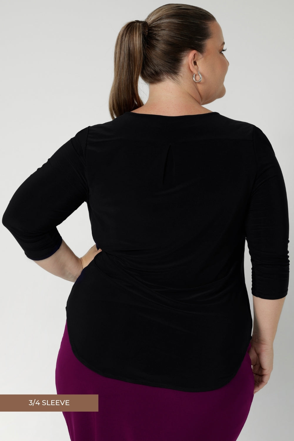 Back view image of size 18 model wears 3/4 sleeved top in black. Crafted in Australia by Leina & Fleur and available for custom pre order now in sizes 8-24.