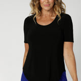 Perfect for layering, it pairs effortlessly under Leina & Fleur suiting jackets and cardigans, creating a polished, refined look. Size 12 over 40's woman wears elbow length sleeve top in black. Pre order now with the choice of 3 different colours and 3 different sleeve lengths at Leina & Fleur in sizes 8-24.