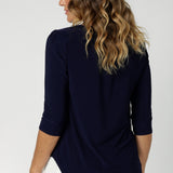 3/4 sleeved top odeal for layering, works brilliantly under Leina & Fleur suiting jackets and cardigans. Adding a refined, polished look to your outfit. Size 12 model wears navy workwear top with white tailored pants. 