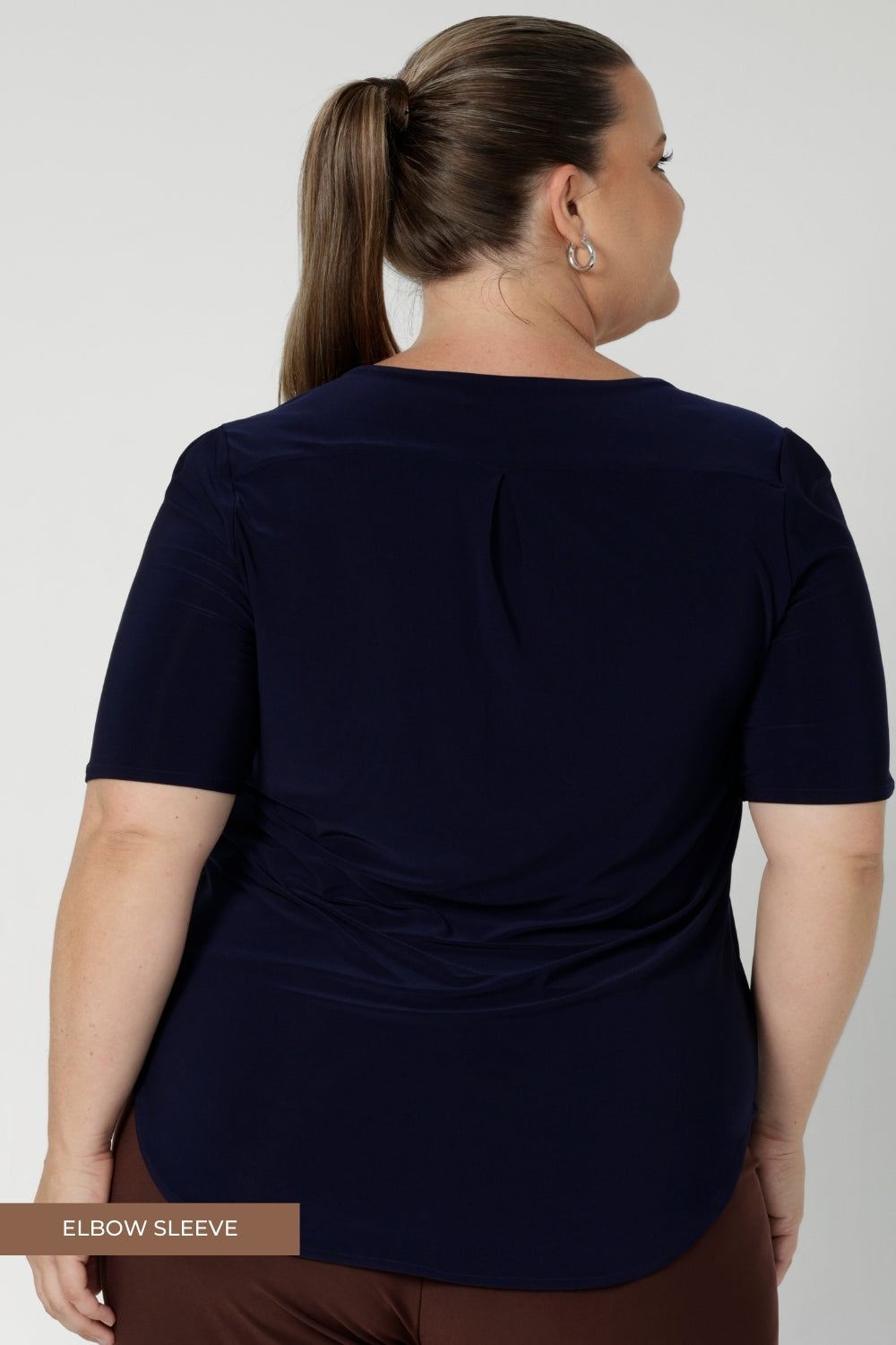 The ultimate travel essential, this top is both comfortable and easy to pack, making it perfect for those on the go. Shirttail hem allows for the option for a tucked in look or elegantly left out over bottoms of choice. Size 8-24.