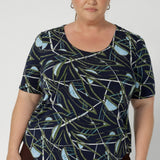 Size 18 woman wears simple yet elegant scoop neckline design, which offers a flattering fit for a variety of body shapes, making it a wardrobe staple. Ideal for layering, it works brilliantly under Leina & Fleur suiting jackets and cardigans, adding a refined, polished look to your outfit. Available for pre order in sizes 8-24.