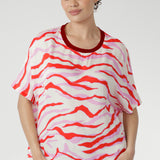 Designed with grown-on sleeves, a round neckline, and a straight hem, it offers a relaxed yet refined fit that flatters every shape. 