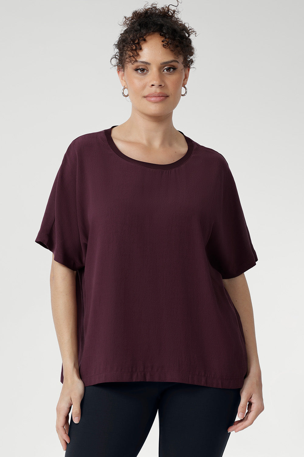 Expertly crafted from premium Tencel Viscose, renowned for its lightweight feel and soft finish. Light Weight top for women is Australian made and stocked in sizes 8-24. Size 10 model pairs her t-shirt with charcoal coloured pants. 