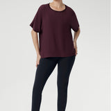 Effortlessly stylish and endlessly versatile, the Scout Tee in Plum is the perfect pairing for your everyday wardrobe. Worn here by a size 10 woman with charcoal-coloured pants, this look captures relaxed elegance with a modern edge.