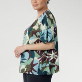 A striking abstract print in green, blue, and plum tones brings a touch of bold personality, while the straight hem makes styling simple—whether worn loose or tucked in.A striking abstract print in green, blue, and plum tones brings a touch of bold personality, while the straight hem makes styling simple—whether worn loose or tucked in.