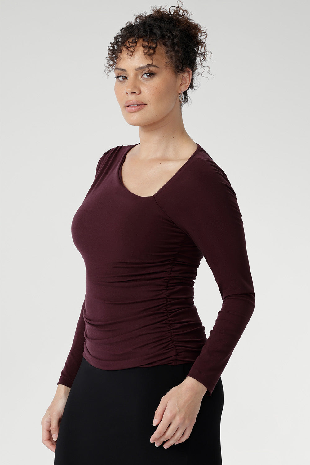 Crafted from a luxurious heavy-weight Lyocell Knit, this top is designed to flatter with its asymmetrical neckline and subtle ruching at the shoulder and sides, creating a soft, sculpted shape. The fully double-layered bodice provides a refined structure, while the long sleeves make it a versatile choice for all seasons.