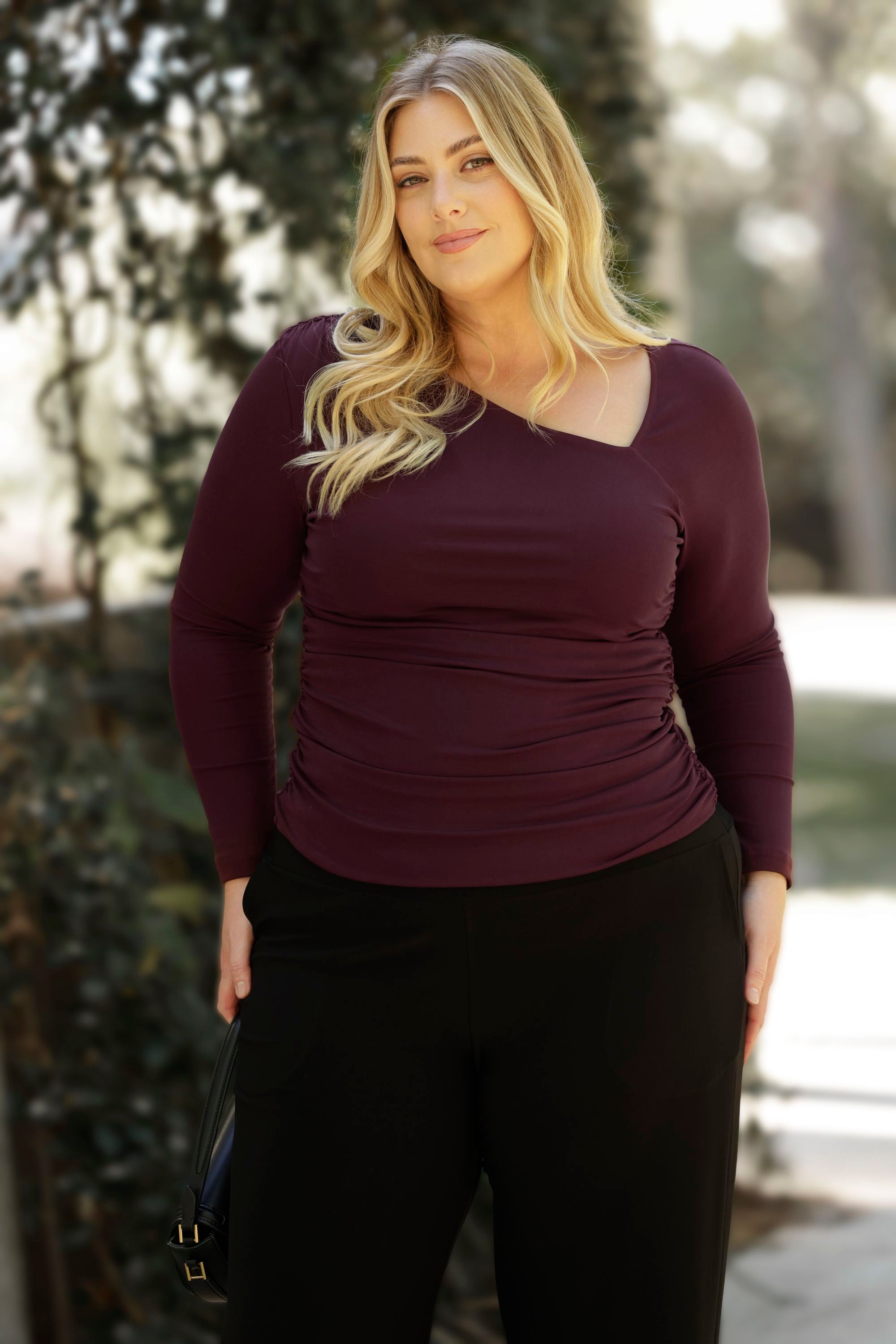 For a more elevated option, the Simmi Top in Wine brings bold sophistication to your wardrobe. Made from a luxe, heavy-weight Lyocell Knit, this flattering top features an eye-catching asymmetrical neckline with artful ruching at the shoulder and sides, creating a sculpted, feminine silhouette.