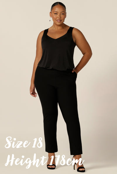 Australian fashion brand Leina & Fleur's monthly model muse, Paris is a plus size woman wearing slim leg black plus size pants and a plus size black cami top with wide shoulder straps.