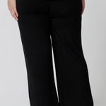 Back view of comfortable loungewear pants in black bamboo jersey. A size 18 woman wears straight wide leg black bamboo lounge pants with a black bamboo slouchy tee top.  Thermo-regulating and breathable this is a great pyjama set for night sweats and hot flushes. Shop plus size lounge and sleepwear online at L&F Australia.