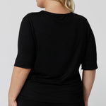 Back view of a sleepwear slouchy tee top, a size 18 woman wears a plus size lounge top in black bamboo. A 3/4 top with high neck, this lounge top is breathable and thermo-regulating so it make good pyjamas for night sweats and hot flushes. Shop loungewear and sleepwear in sizes 8 to 24 online at L&F Australia.